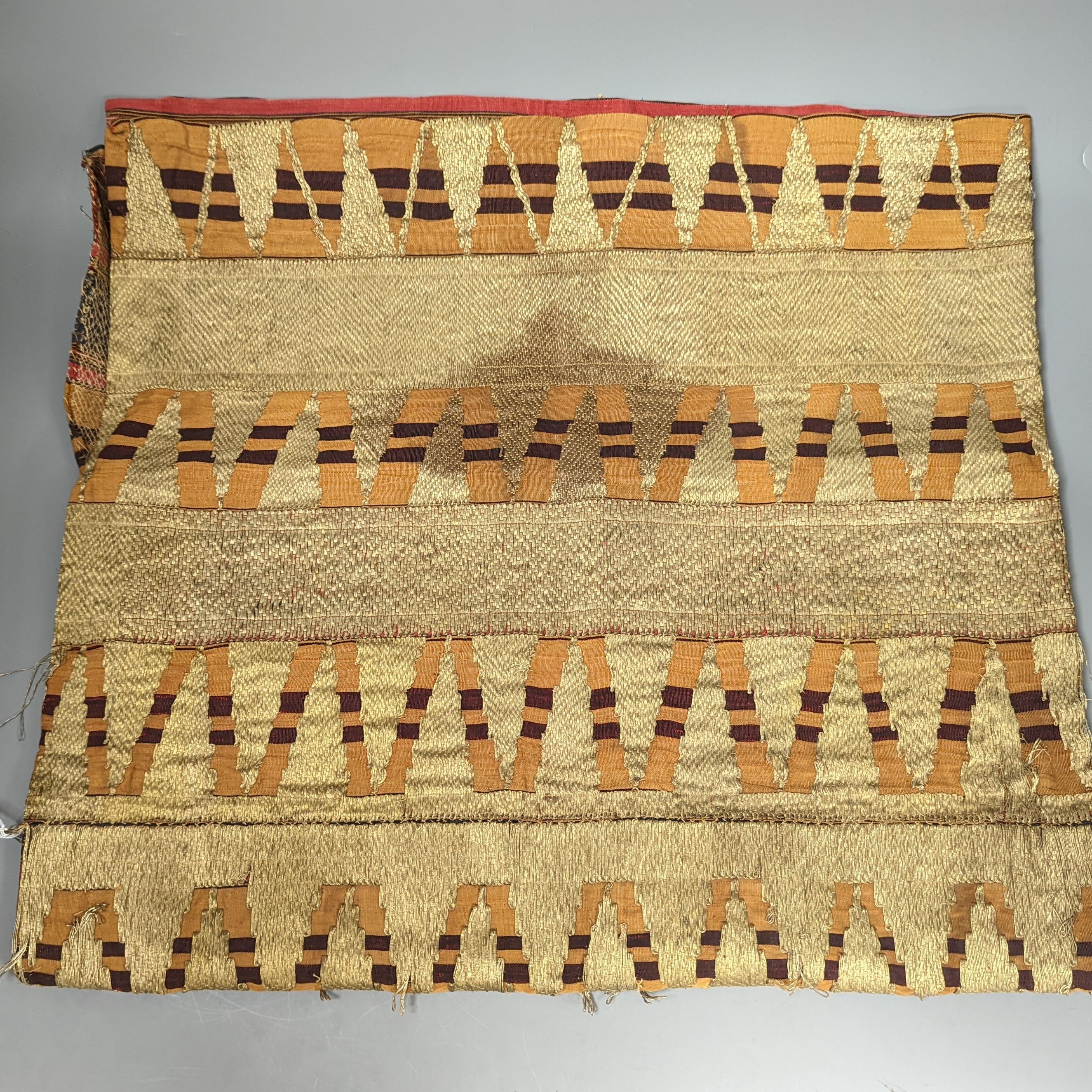 An Indian stripe silk woven panel, covered with gold metallic embroidery, 102 cms long x 98 cms wide.